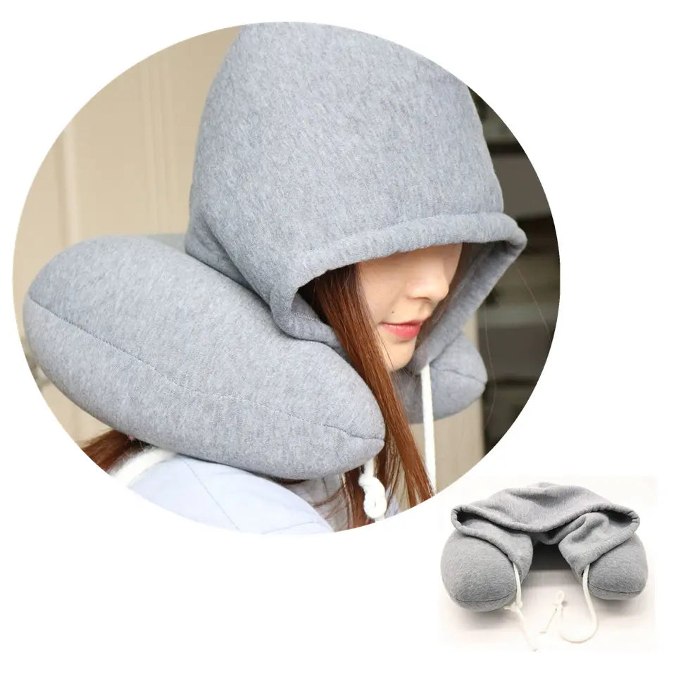 Hooded travel neck pillow with soft hood and ergonomic memory foam support for comfortable sleeping while traveling.