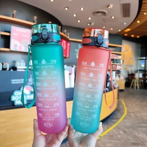 Motivational water bottles displayed in a retail setting showing various color choices.