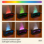 Six-panel product collage showing a rectangular black diffuser or candle holder with a glowing flame effect and mist rising from the top, demonstrated in different color modes: red, green, aqua, blue, purple, and white. A rainbow color strip appears at the top, and text at the bottom reads 'Colorful ambient light' and 'Soft light without glare'.

