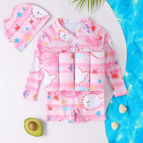 Children's pink swimsuit with cartoon designs on a white surface with pool elements.

