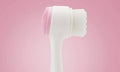 Pink Background Product Shot of Manual Face Cleansing Brush