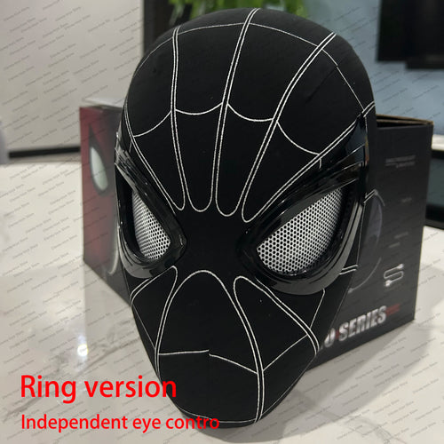 Black spider-themed mask with white accents on a reflective surface

