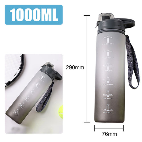 Transparent sports bottle with flip-top lid and carrying handle.