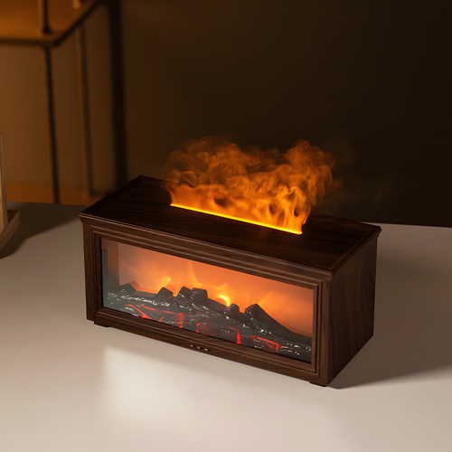 A rectangular electric fireplace tabletop insert with a dark wood-grain finish, featuring a glowing orange and yellow faux flame effect and realistic black logs with red embers inside a glass-front cabinet, shown on a white tabletop against a dark background.

