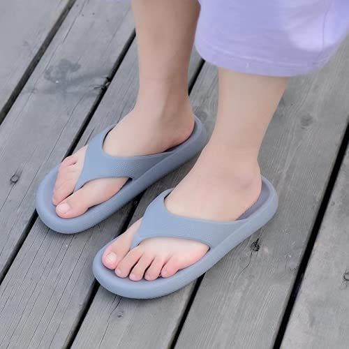 Gray sandals worn on a wooden floor

