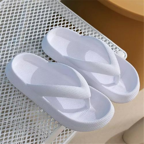White flip-flops on a textured surface

